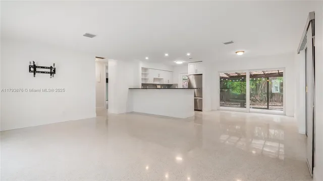 a view of a kitchen with a sink and a large window