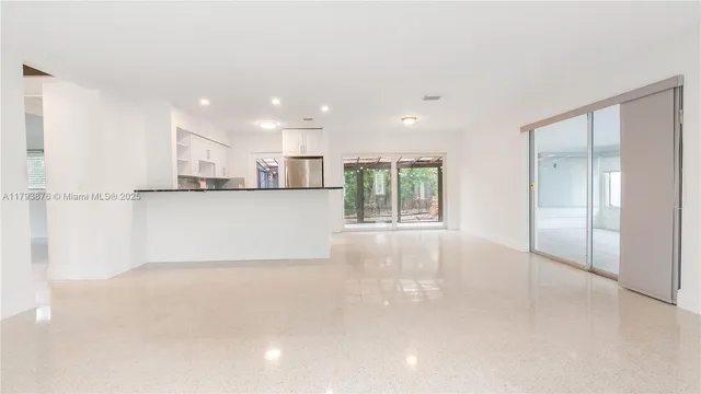 a kitchen with a sink cabinets stainless steel appliances and a window