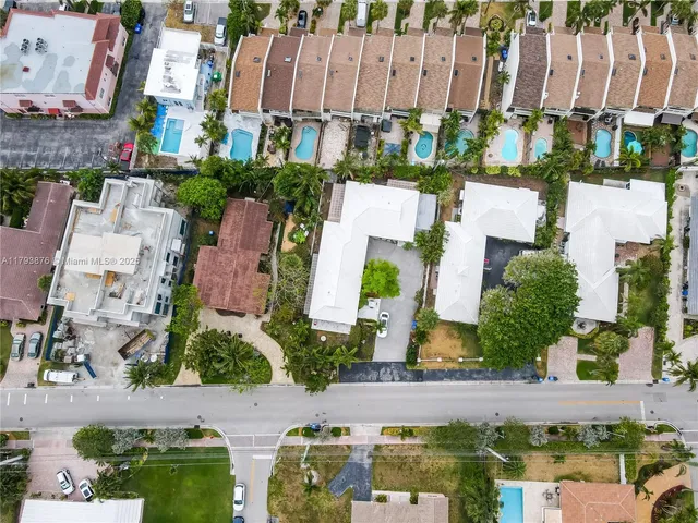 an aerial view of a house with a yard and garden