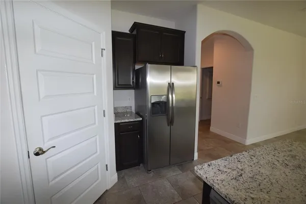 a kitchen with a refrigerator and countertop