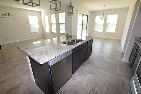 a large kitchen with granite countertop a sink and dishwasher with a granite countertops