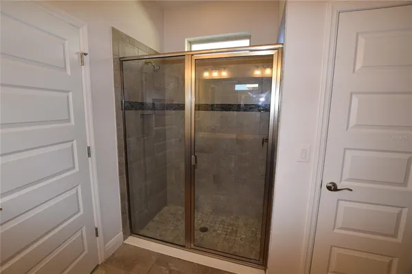 a bathroom with a glass shower door