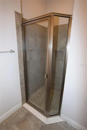 a bathroom with a glass shower door