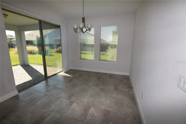 a view of an empty room with glass door