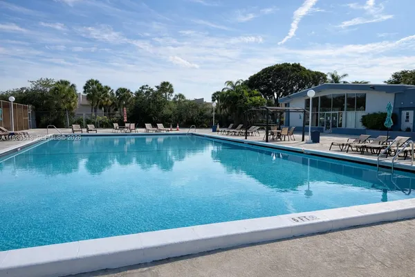 a view of a swimming pool with an outdoor seating