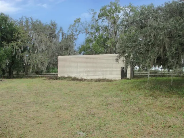 a view of a field with a tree in the background