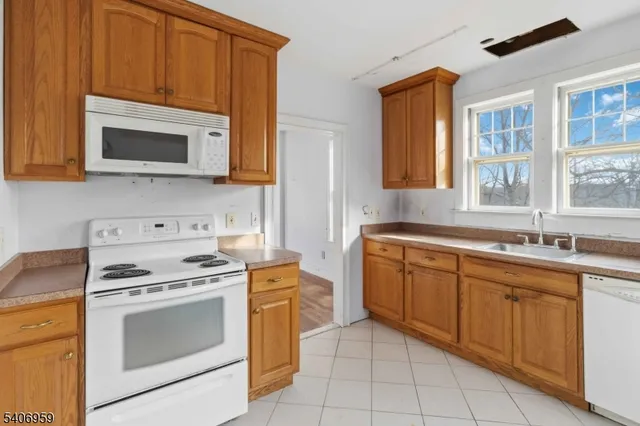 a kitchen with stainless steel appliances granite countertop a stove microwave and sink