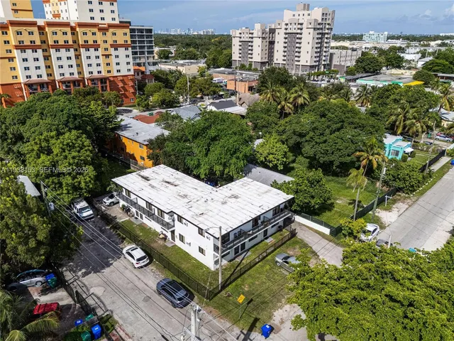 an aerial view of a houses with a yard