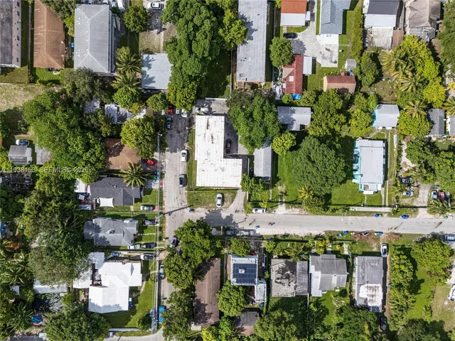an aerial view of multiple houses with yard