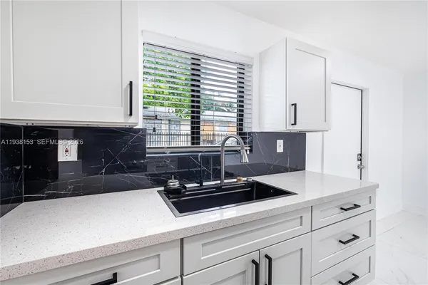a kitchen with stainless steel appliances a refrigerator and a stove