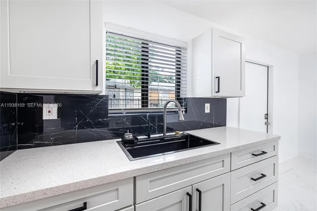 a kitchen with stainless steel appliances a refrigerator and a stove