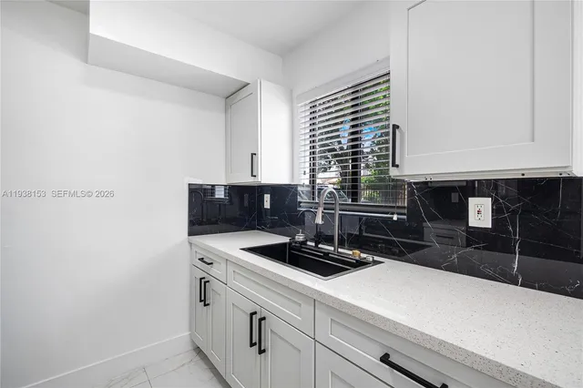 a kitchen with stainless steel appliances a sink a stove and a refrigerator