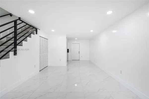 a view of an empty room with stairs
