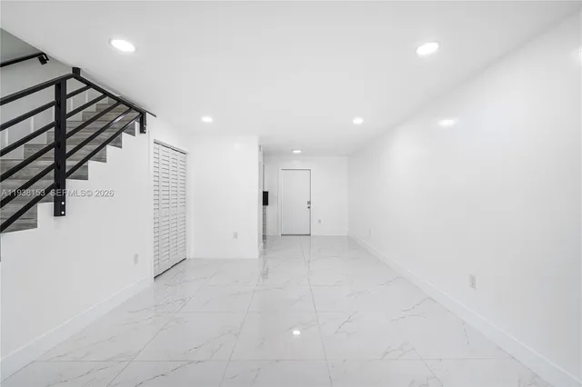 a view of an empty room with stairs