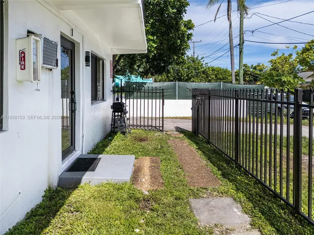a view of a house with a yard and sitting area