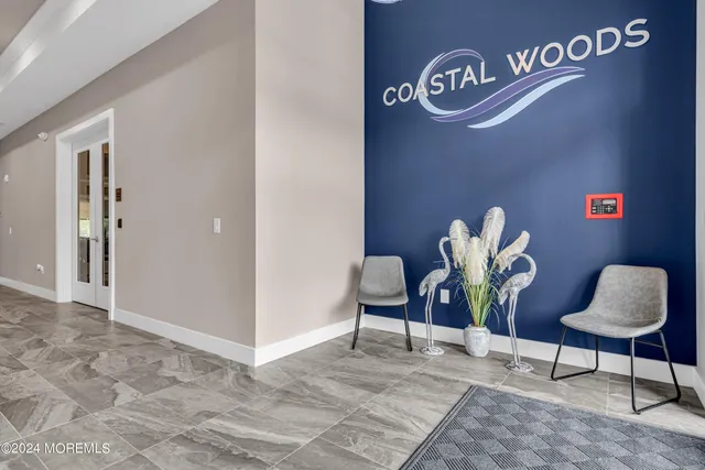 a kitchen with stainless steel appliances granite countertop wooden floors wooden cabinets dining table and chairs