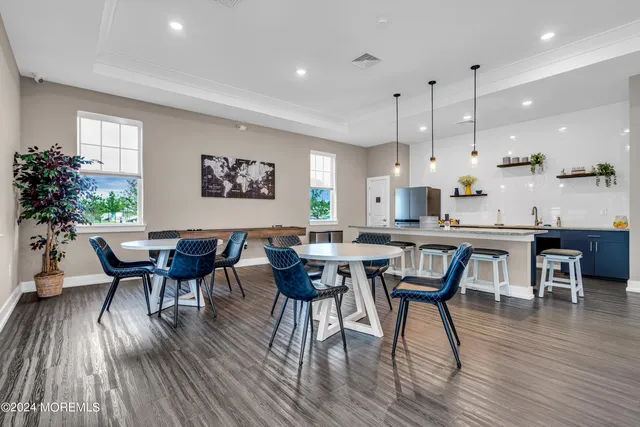 a view of a dining room with furniture wooden floor and chandelier