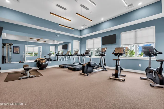 a view of empty room with wooden floor and windows