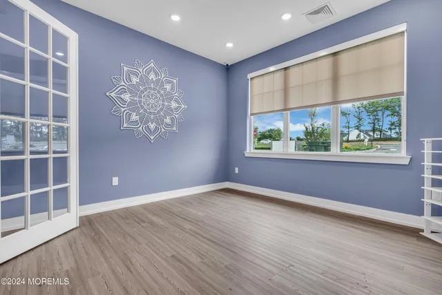 a living room with furniture flat screen tv and wooden floor