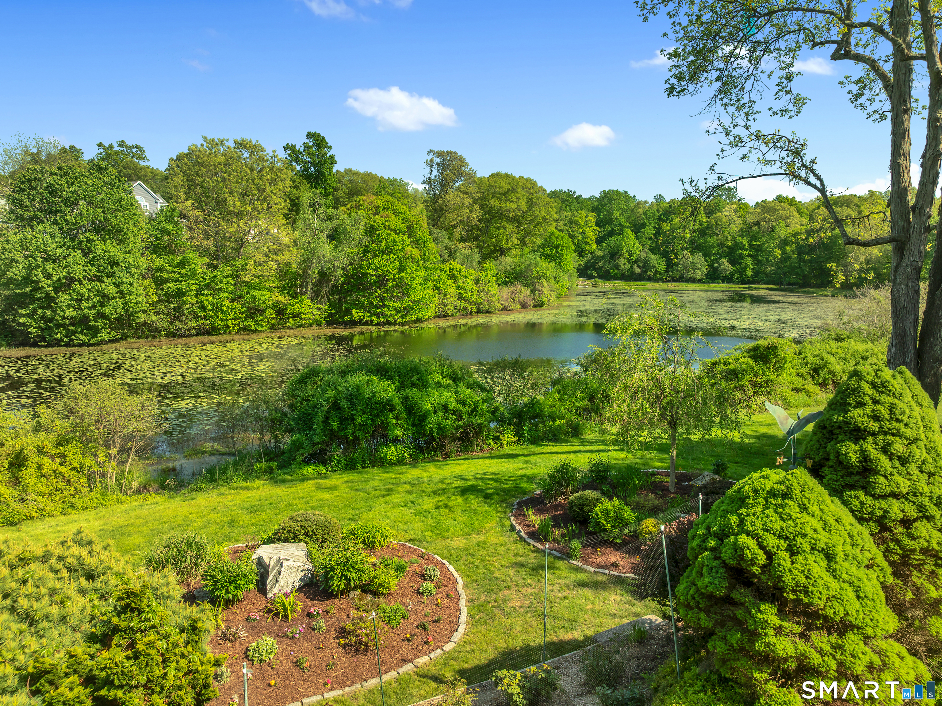 194 Quaker Farms Road Oxford, CT 06478 - Photo 36 of 40 a view of a garden with a lake