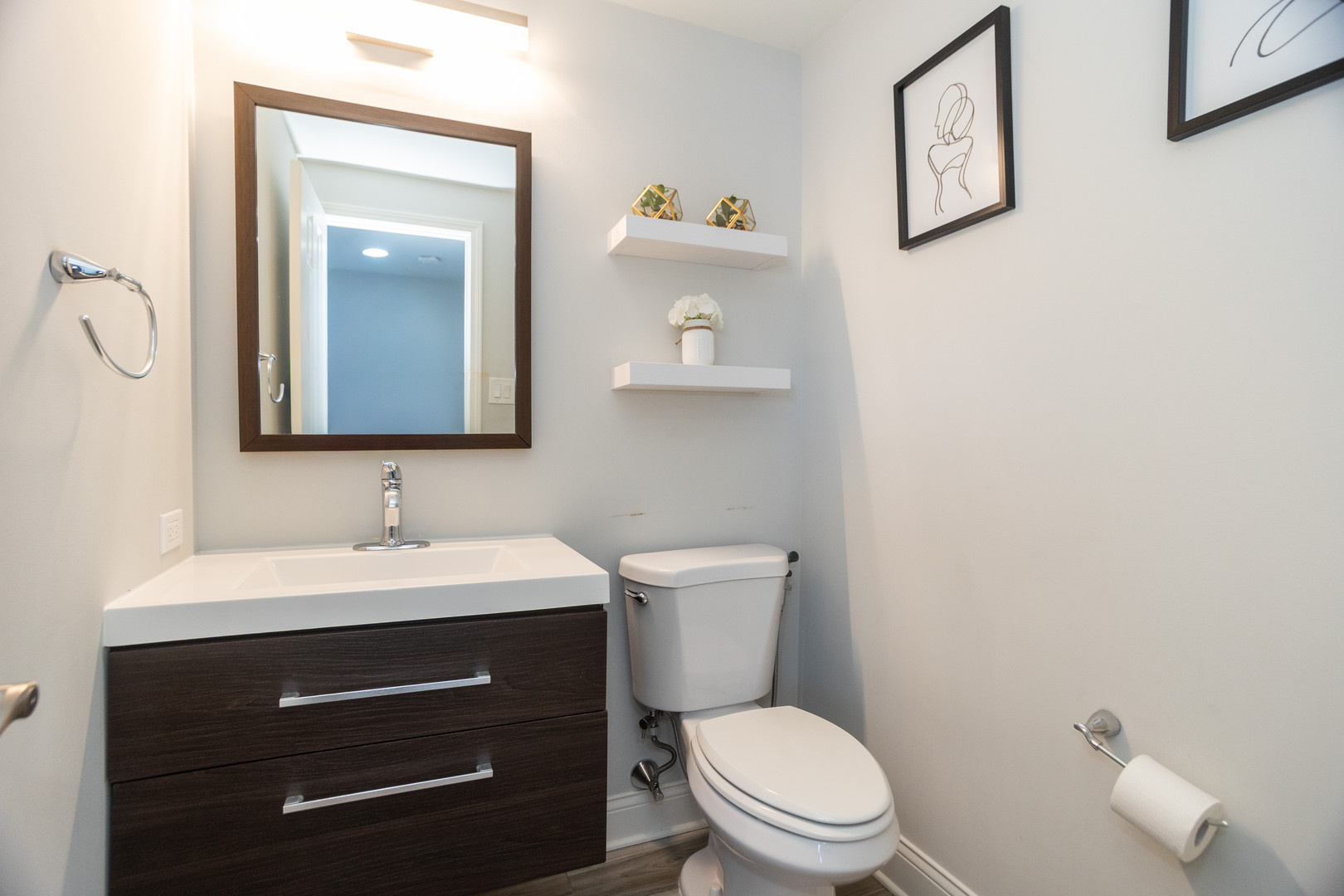14451 South Ravinia Avenue, Unit 1 Orland Park, IL 60462 - Photo 11 of 22 a bathroom with a toilet sink vanity and mirror