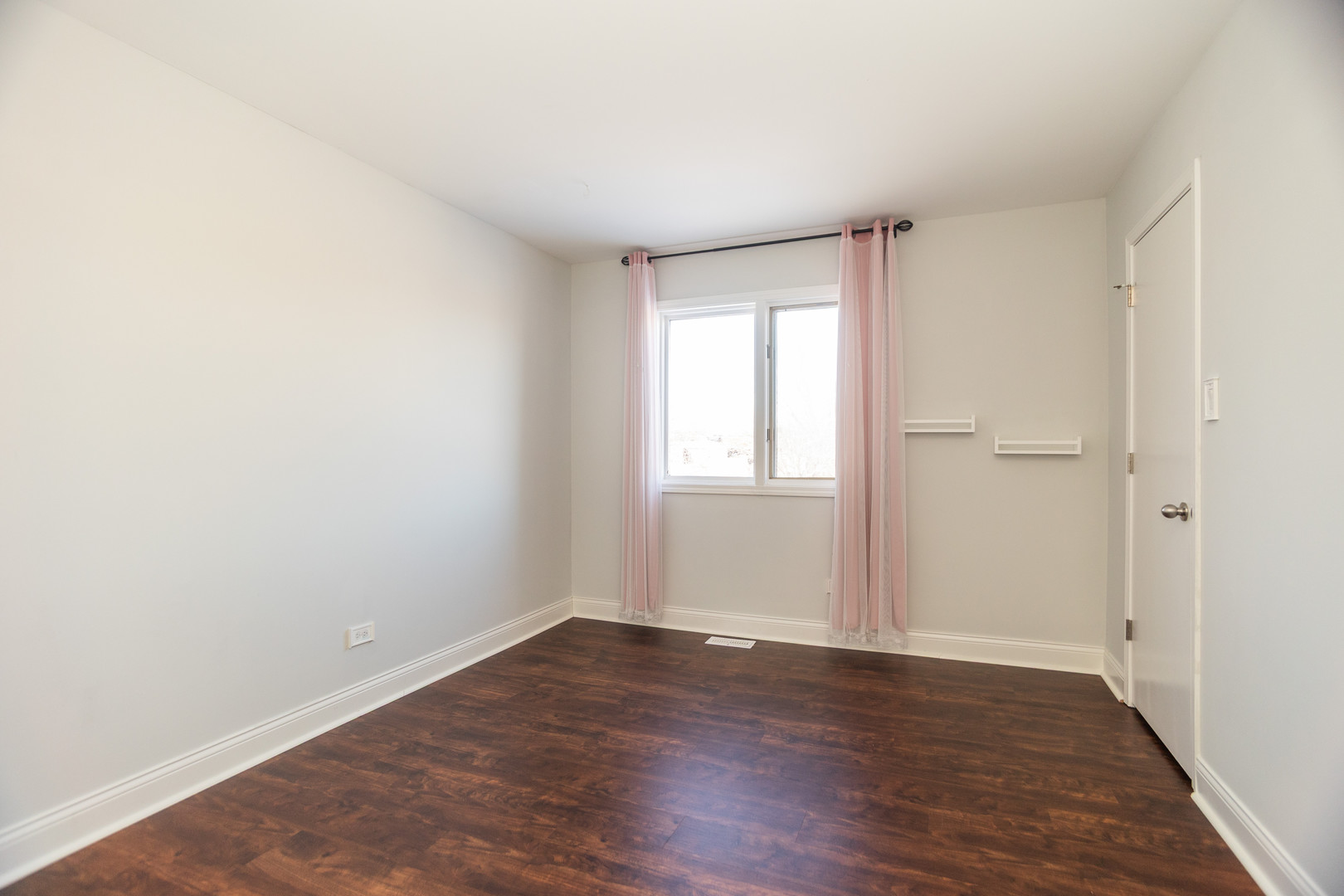 14451 South Ravinia Avenue, Unit 1 Orland Park, IL 60462 - Photo 13 of 22 an empty room with wooden floor and windows