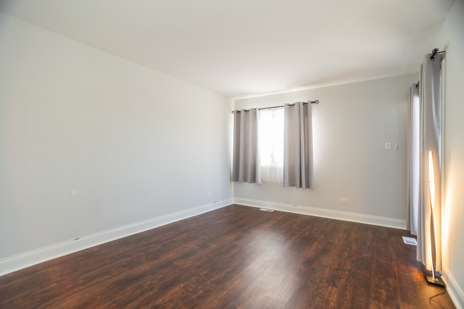 14451 South Ravinia Avenue, Unit 1 Orland Park, IL 60462 - Photo 15 of 22 an empty room with wooden floor and windows