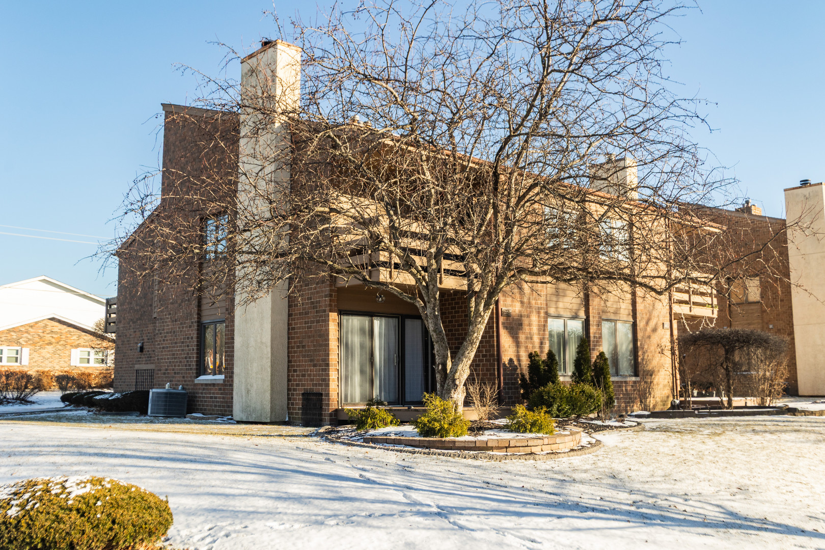 14451 South Ravinia Avenue, Unit 1 Orland Park, IL 60462 - Photo 19 of 22 a view of a building with trees