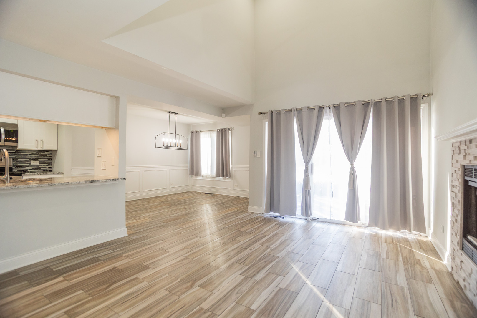 14451 South Ravinia Avenue, Unit 1 Orland Park, IL 60462 - Photo 5 of 22 a view of a kitchen with wooden floor and a window