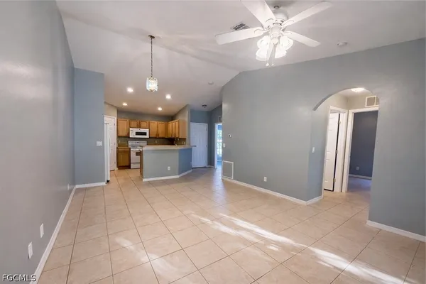 a view of a kitchen with a sink and a refrigerator