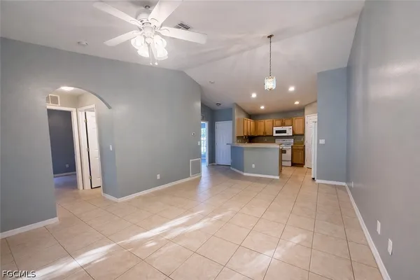 a view of a kitchen with a sink and a refrigerator