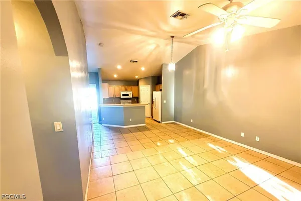 a view of a kitchen with a sink and a refrigerator