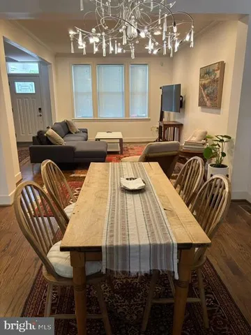 a view of a dining room with furniture and chandelier