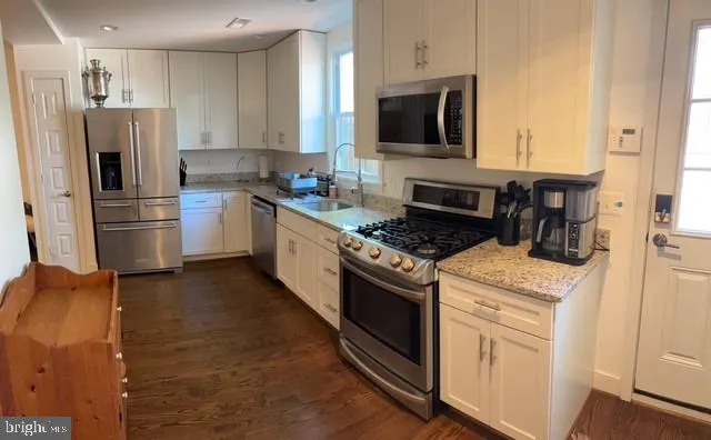a kitchen with a refrigerator stove and microwave