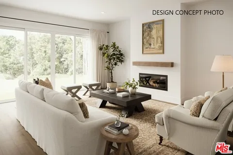 a living room with furniture fireplace and a large window