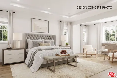 a bedroom with a bed a couch and large window