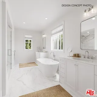 a spacious bathroom with a bathtub sink and mirror