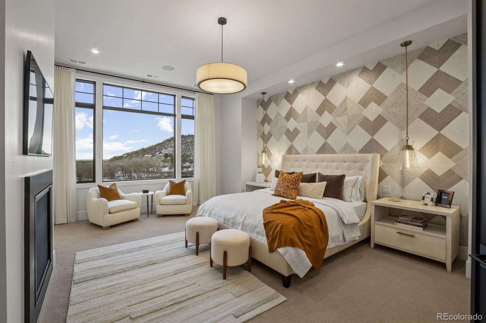 5132 Mount Glennon Way Morrison, CO 80465 - Photo 20 of 40 a bedroom with a bed and a chandelier