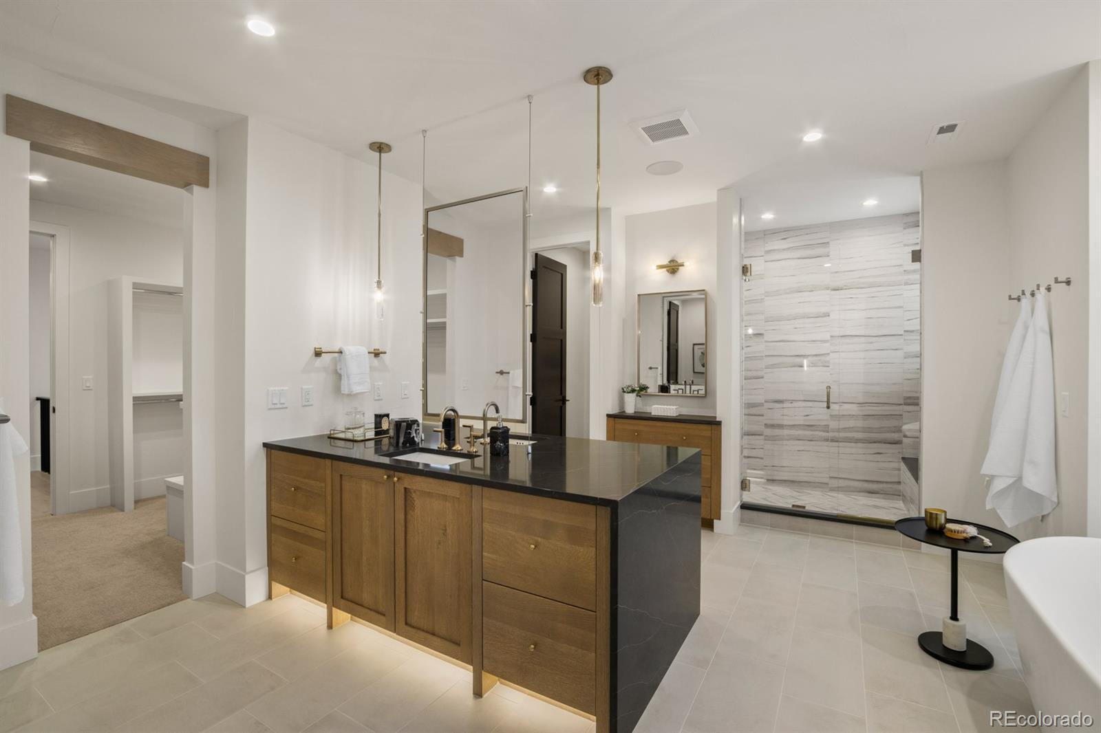 5132 Mount Glennon Way Morrison, CO 80465 - Photo 22 of 40 a bathroom with a double sink shower and a mirror