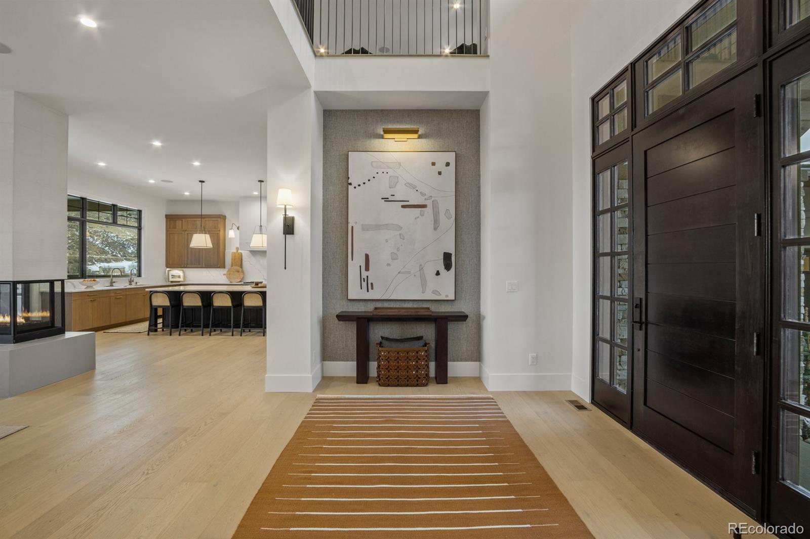 5132 Mount Glennon Way Morrison, CO 80465 - Photo 3 of 40 a view of a hallway with wooden floor and seating space