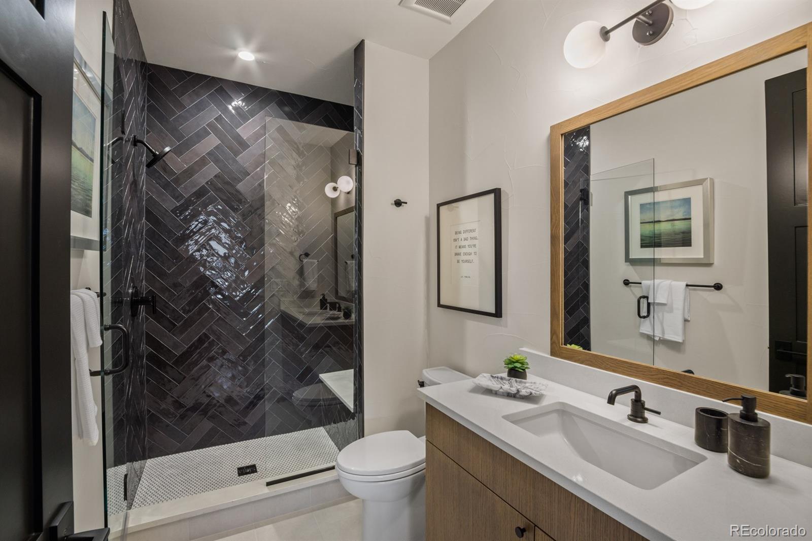 5132 Mount Glennon Way Morrison, CO 80465 - Photo 31 of 40 a bathroom with a sink a toilet and shower