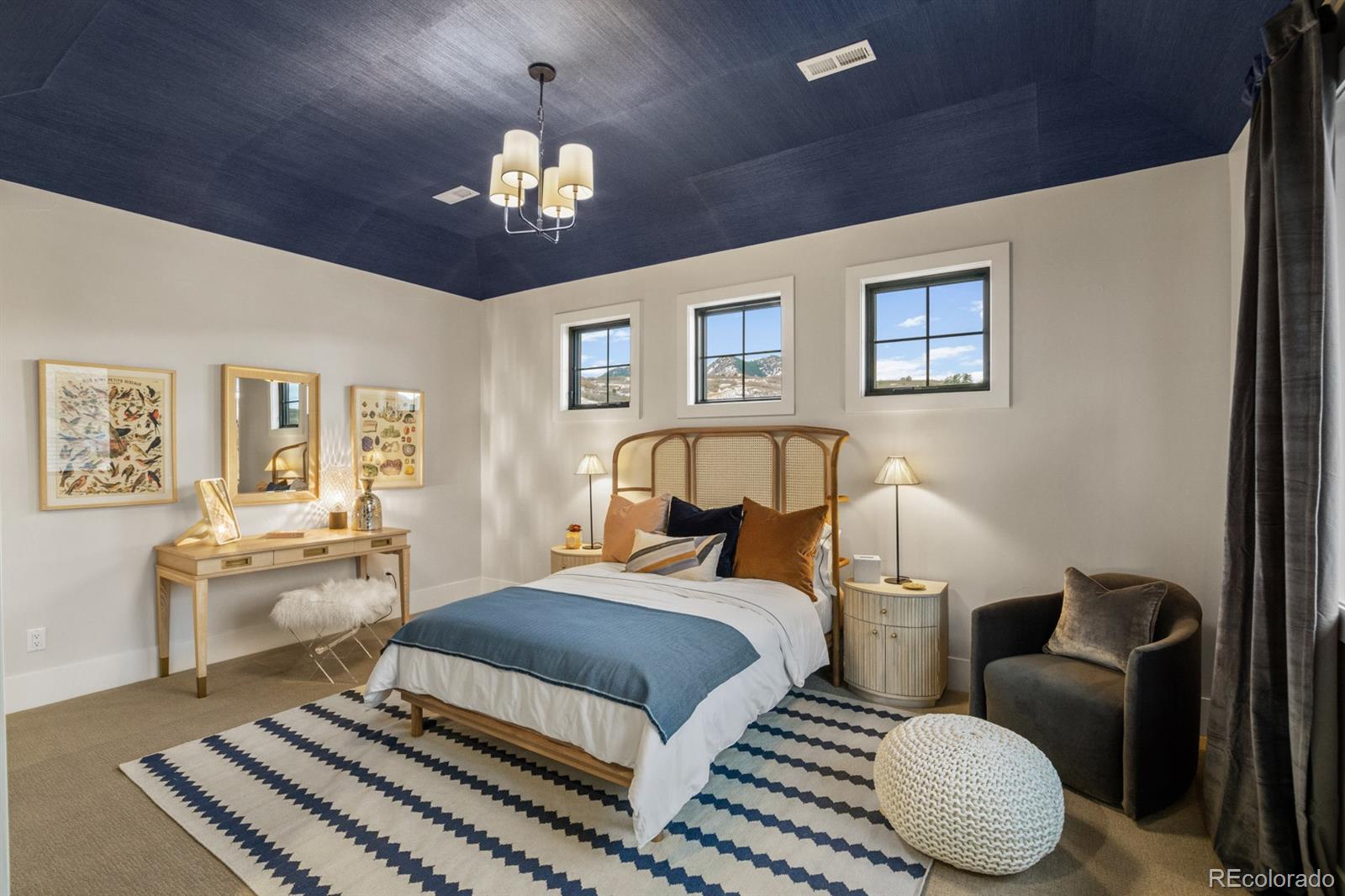 5132 Mount Glennon Way Morrison, CO 80465 - Photo 32 of 40 a bedroom with a bed and a chandelier