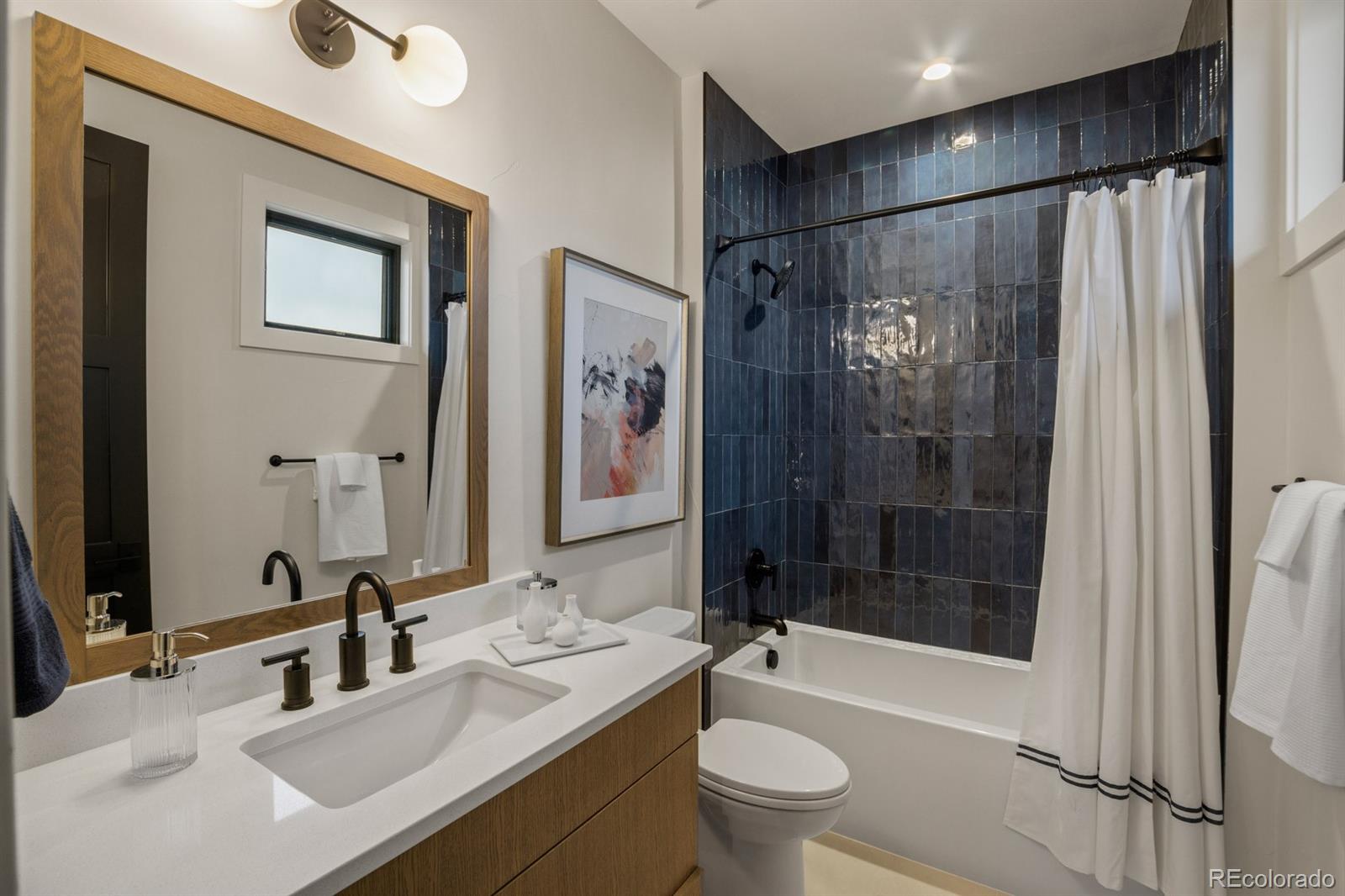 5132 Mount Glennon Way Morrison, CO 80465 - Photo 33 of 40 a bathroom with a double vanity sink toilet mirror and shower