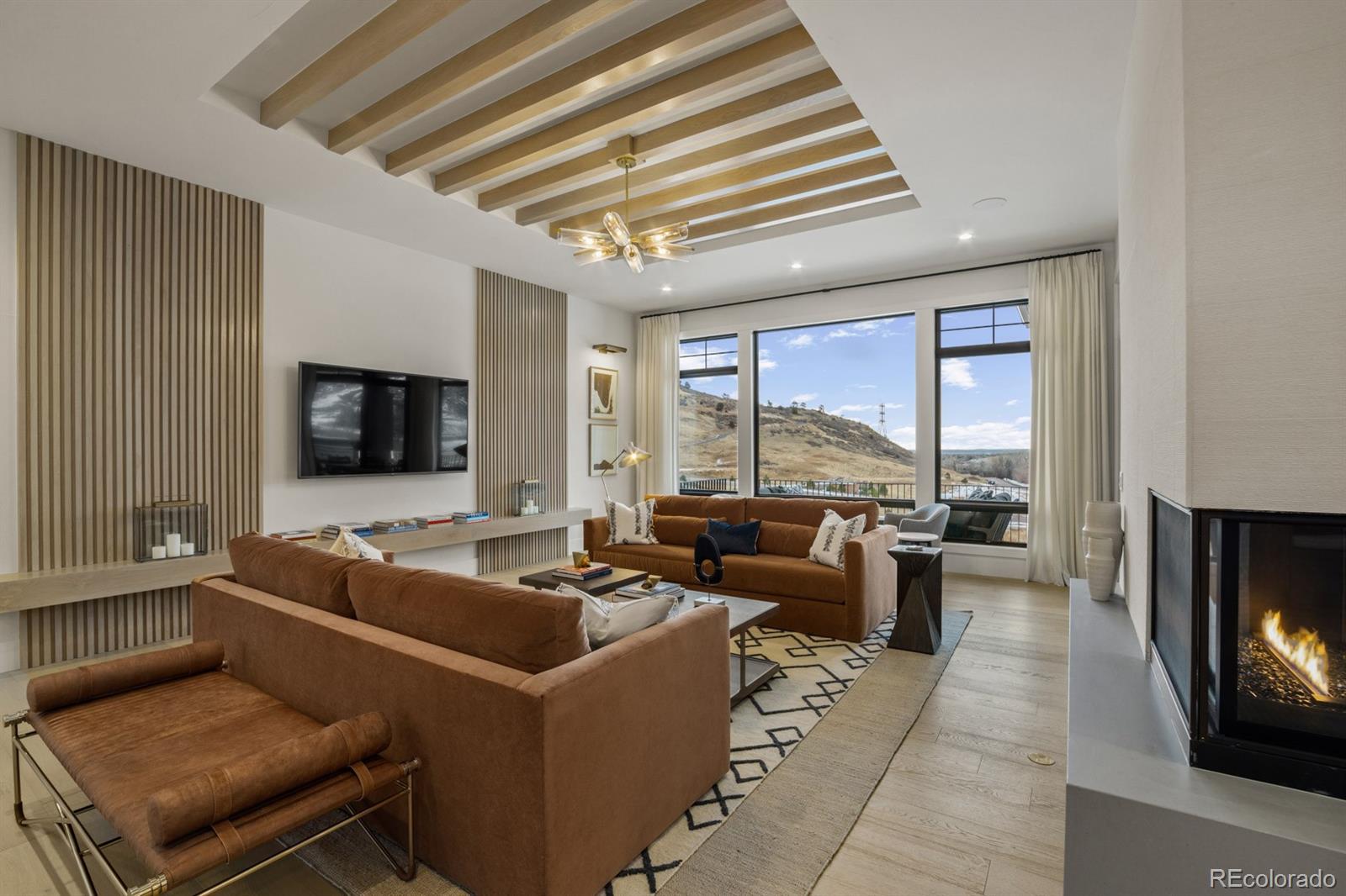 5132 Mount Glennon Way Morrison, CO 80465 - Photo 5 of 40 a living room with furniture and a flat screen tv