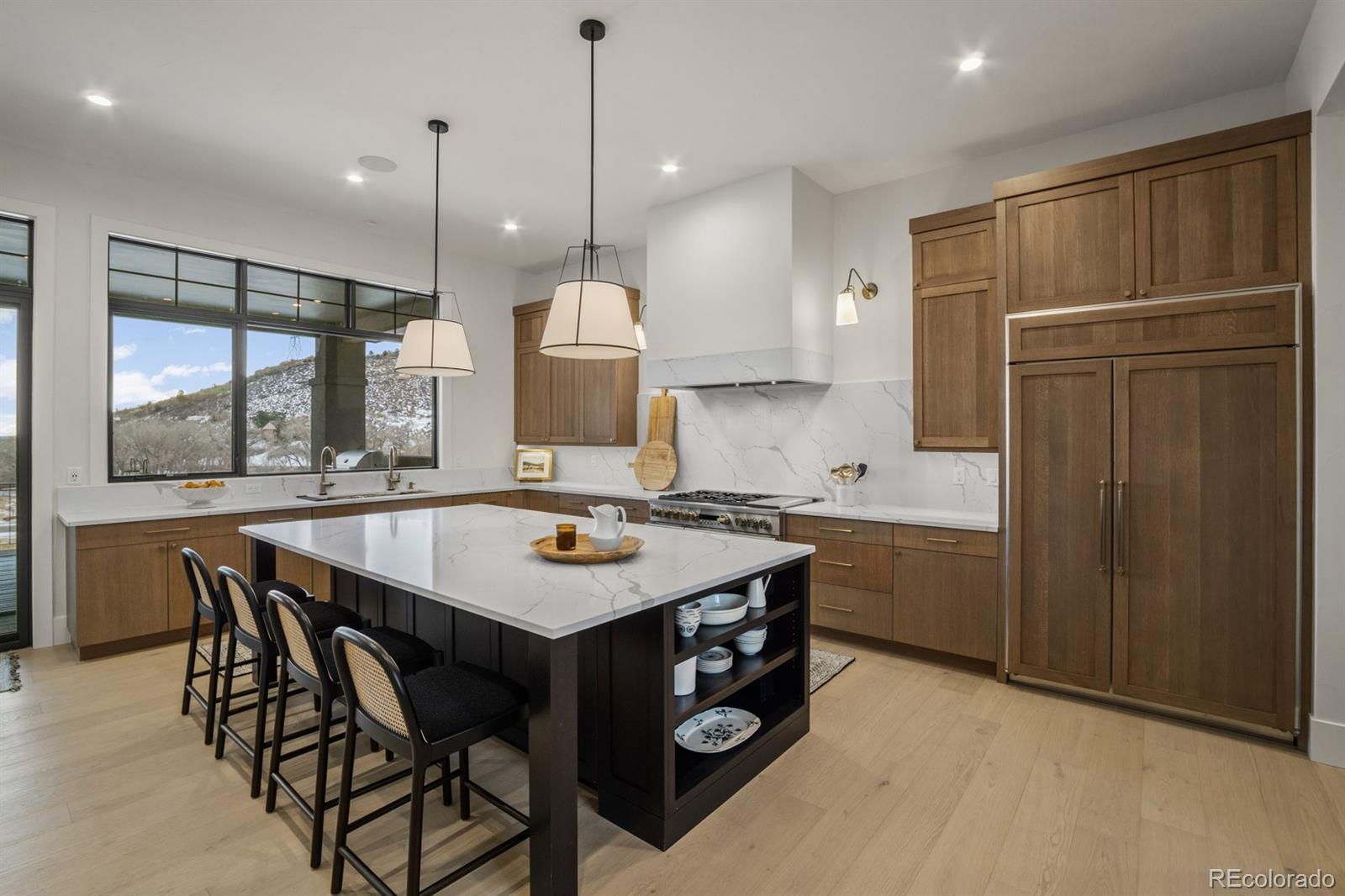 5132 Mount Glennon Way Morrison, CO 80465 - Photo 7 of 40 a kitchen with a table chairs refrigerator and microwave