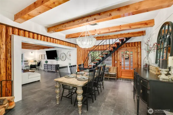 a dining room with furniture and a flat screen tv
