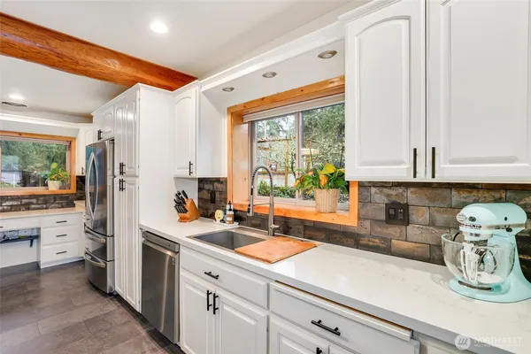 a kitchen with a sink stove and cabinets