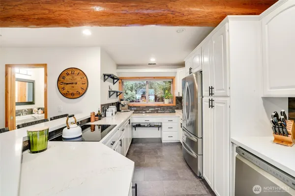 a kitchen with a refrigerator and a stove