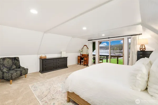 a spacious bedroom with a bed and a large window