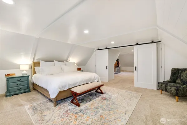 a spacious bedroom with a bed and a couch